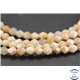 Perles semi précieuses en pierre de soleil - Toupies/6 mm - Rose saumon